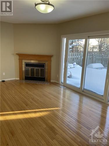 Living Room w/ Fireplace. Access to backyard. - 6 Pinetrail Crescent, Ottawa, ON - Indoor Photo Showing Living Room With Fireplace