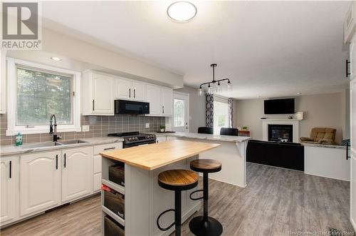 853 Melanson Road, Dieppe, NB - Indoor Photo Showing Kitchen With Fireplace With Double Sink