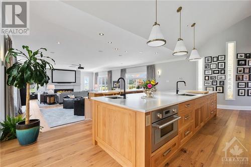 Newly installed white oak flooring along with custom cut area rugs for both family room and sitting area. - 144 Kerry Hill Crescent, Ottawa, ON - Indoor Photo Showing Kitchen