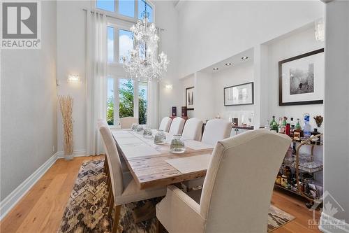 Formal dining area with soaring window wall and vaulted ceilings - 144 Kerry Hill Crescent, Ottawa, ON - Indoor Photo Showing Dining Room