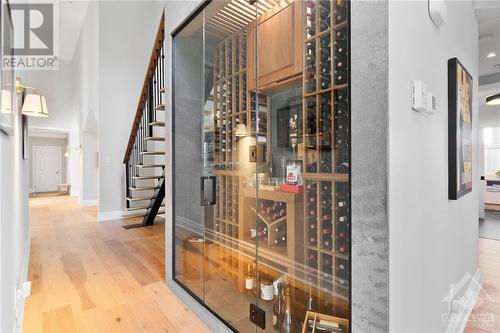 Custom built refrigerated wine cellar closet tucked below the loft staircase and close to the dining areas - 144 Kerry Hill Crescent, Ottawa, ON - Indoor Photo Showing Other Room