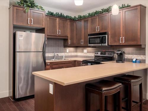 304-6310 Mcrobb Ave, Nanaimo, BC - Indoor Photo Showing Kitchen With Stainless Steel Kitchen With Double Sink