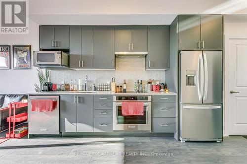 325 - 3220 William Coltson Ave Avenue E, Oakville, ON - Indoor Photo Showing Kitchen With Stainless Steel Kitchen