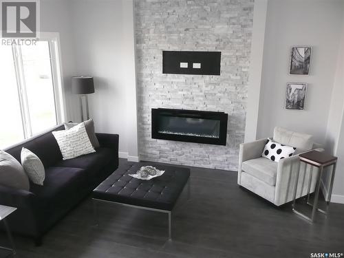 1051 Brighton Gate, Saskatoon, SK - Indoor Photo Showing Living Room With Fireplace