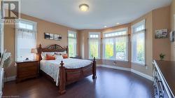 Primary bedroom suite with walk-in closet and 4-piece en suite overlooks the private backyard. - 