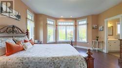 Primary bedroom suite with walk-in closet and 4-piece en suite overlooks the private backyard. - 