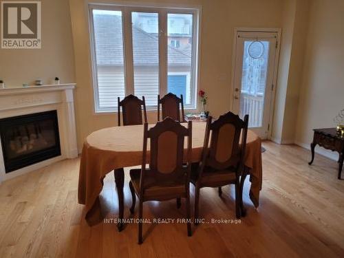 23 Hackett Avenue, Toronto, ON - Indoor Photo Showing Dining Room With Fireplace