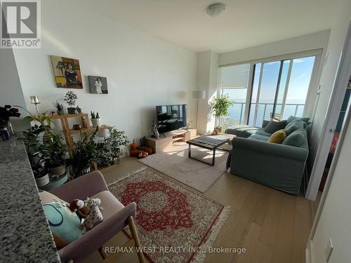 3409 - 20 Shore Breeze Drive E, Toronto, ON - Indoor Photo Showing Living Room With Fireplace