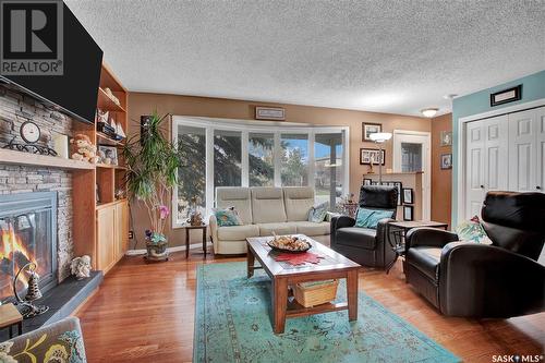 702 4Th Street S, Martensville, SK - Indoor Photo Showing Living Room With Fireplace