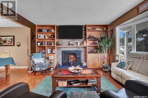 702 4Th Street S, Martensville, SK - Indoor Photo Showing Living Room With Fireplace