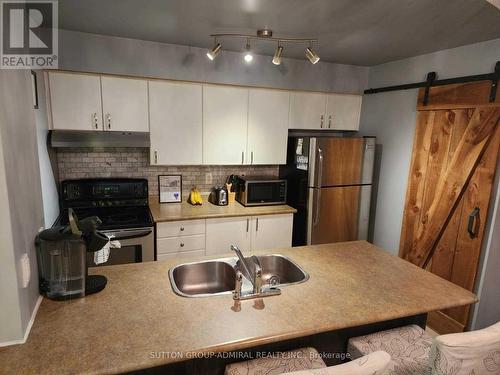 207 - 90 Aspen Springs Drive, Clarington, ON - Indoor Photo Showing Kitchen With Double Sink