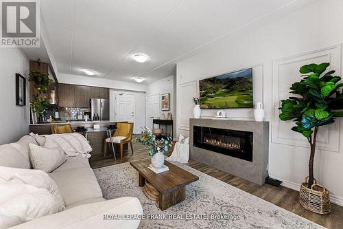 218 - 290 Liberty Street N, Clarington (Bowmanville), ON - Indoor Photo Showing Living Room With Fireplace