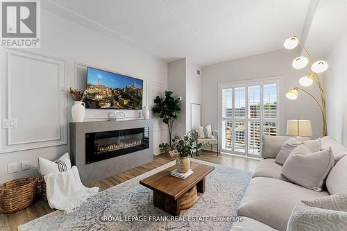 218 - 290 Liberty Street N, Clarington (Bowmanville), ON - Indoor Photo Showing Living Room With Fireplace