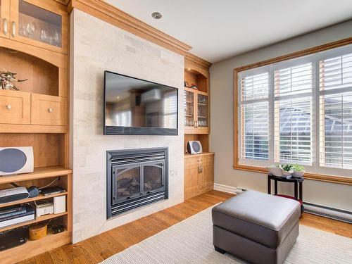 Family room - 6795 Rue Des Coquelicots, Longueuil (Saint-Hubert), QC - Indoor Photo Showing Living Room With Fireplace