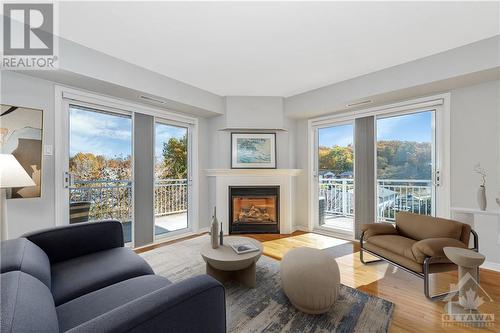 Photo Virtually Staged - 134 Edwards Street Unit#201, Rockland, ON - Indoor Photo Showing Living Room With Fireplace