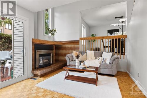 brand new main door and new flooring in foyer - 17 Welby Court, Ottawa, ON - Indoor Photo Showing Living Room With Fireplace