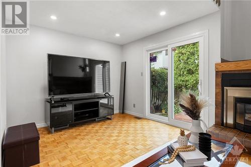 brand new sliding door to backyard and deck - 17 Welby Court, Ottawa, ON - Indoor Photo Showing Living Room With Fireplace