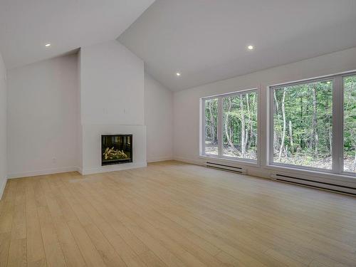 Living room - 128 Rue Béatrice, Saint-Colomban, QC - Indoor Photo Showing Other Room With Fireplace