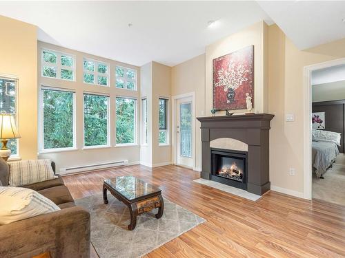 303-5660 Edgewater Lane, Nanaimo, BC - Indoor Photo Showing Living Room With Fireplace