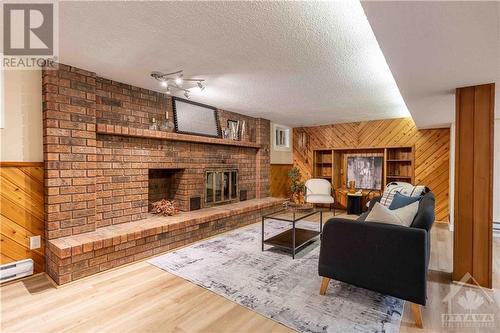 Recreation Room with Wood Fireplace - 3027 Prince Of Wales Drive, Ottawa, ON - Indoor Photo Showing Living Room With Fireplace