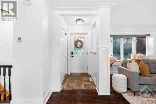 Foyer with front closet & Bay Windows in Living Room with Window Seating - 3027 Prince Of Wales Drive, Ottawa, ON - Indoor Photo Showing Other Room