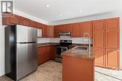 Kitchen featuring granite countertops and plenty of cupboard space - 