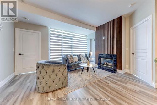 402 - 3939 Duke Of York Boulevard, Mississauga, ON - Indoor Photo Showing Living Room With Fireplace