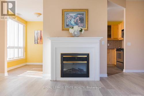 305 - 2000 Creekside Drive, Hamilton, ON - Indoor Photo Showing Living Room With Fireplace