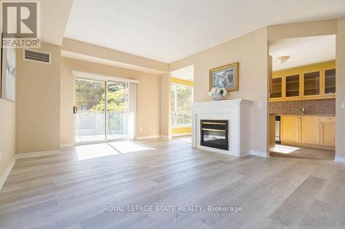 305 - 2000 Creekside Drive, Hamilton, ON - Indoor Photo Showing Living Room With Fireplace