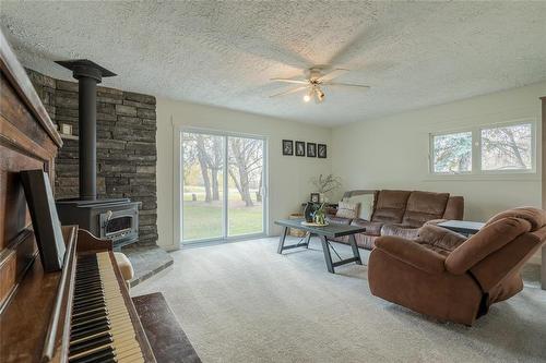 45005 33N Road, La Broquerie, MB - Indoor Photo Showing Living Room With Fireplace