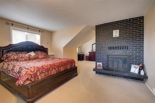 3310 Mathews Road, Kelowna, BC - Indoor Photo Showing Bedroom With Fireplace