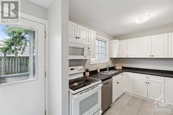 Kitchen w/ dining area & entrance to backyard - 