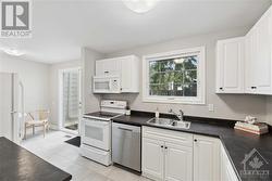 Kitchen w/ dining area & entrance to backyard - 