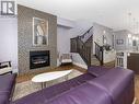 344 Quarry Park Boulevard Se, Calgary, AB  - Indoor Photo Showing Living Room With Fireplace 