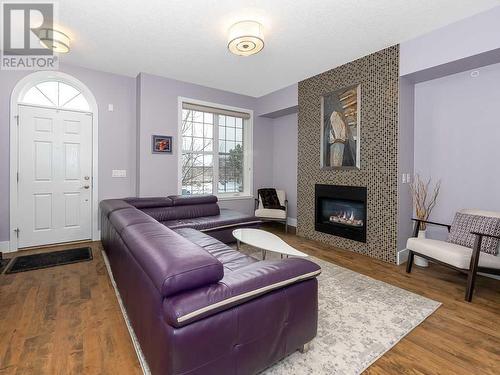 344 Quarry Park Boulevard Se, Calgary, AB - Indoor Photo Showing Living Room With Fireplace