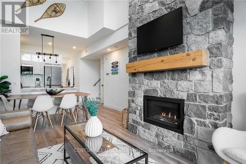 406 - 16 Beckwith Lane W, Blue Mountains, ON - Indoor Photo Showing Living Room With Fireplace