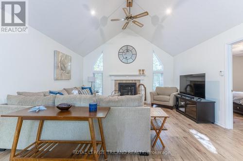 Inviting living room with vaulted ceiling - 10248 Pinetree Drive, Lambton Shores (Grand Bend), ON - Indoor Photo Showing Living Room With Fireplace