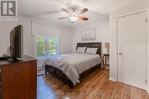 Primary bedroom with large window - 10248 Pinetree Drive, Lambton Shores (Grand Bend), ON - Indoor Photo Showing Bedroom