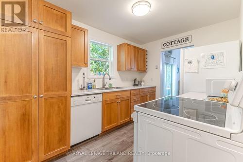 Warm and welcoming kitchen cabinetry - 10248 Pinetree Drive, Lambton Shores (Grand Bend), ON - Indoor Photo Showing Kitchen With Double Sink