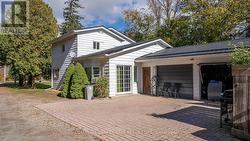 Brick patio to sliding door and double garage. - 