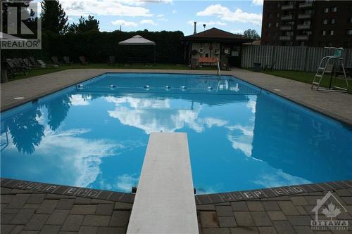 Outdoor pool is salt water. - 3100 Carling Avenue Unit#907, Ottawa, ON - Outdoor With In Ground Pool With Backyard