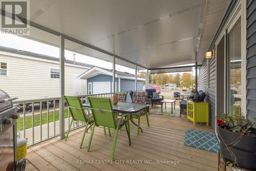 Relax on this large covered deck - E40 - 4340 Cromarty Drive N, Thames Centre (Mossley), ON - Outdoor With Deck Patio Veranda With Exterior