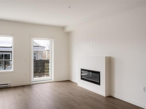 202-9716 Third St, Sidney, BC - Indoor Photo Showing Living Room With Fireplace