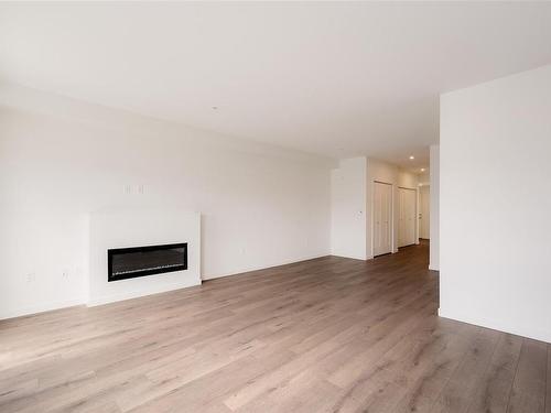 303-9716 Third St, Sidney, BC - Indoor Photo Showing Living Room With Fireplace