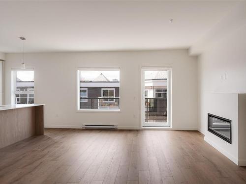 303-9716 Third St, Sidney, BC - Indoor Photo Showing Living Room With Fireplace