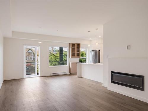 203-9716 Third St, Sidney, BC - Indoor Photo Showing Living Room With Fireplace