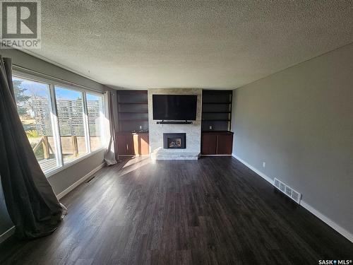 13 Mountain Drive, Carlyle, SK - Indoor Photo Showing Living Room With Fireplace