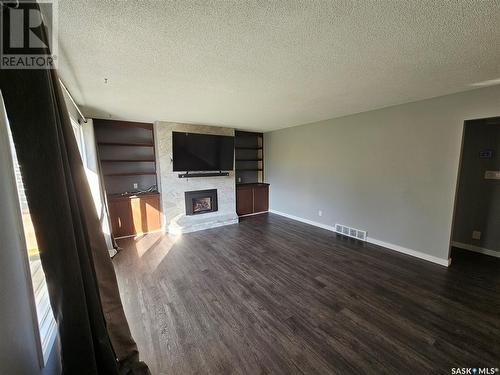 13 Mountain Drive, Carlyle, SK - Indoor Photo Showing Living Room With Fireplace