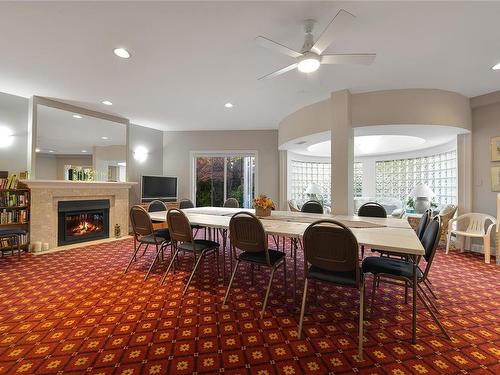 302-3969 Shelbourne St, Saanich, BC - Indoor Photo Showing Dining Room With Fireplace