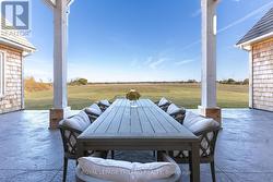 Outdoor dining area overlooking rolling pastures. - 